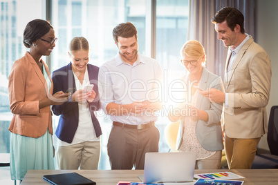 Group of business people text messaging on mobile phone