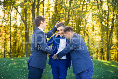 Friends laughing at the wedding of a friend