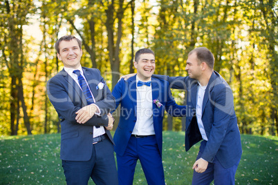 Friends laughing at the wedding of a friend