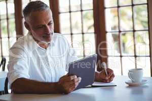 Man using tablet and notebook