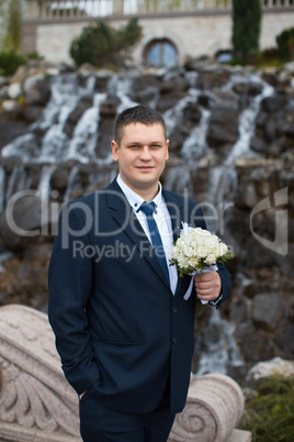 Portrait groom in nature