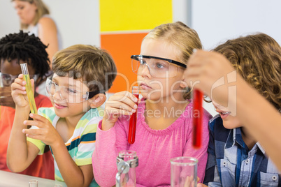 Kids doing a chemical experiment in laboratory