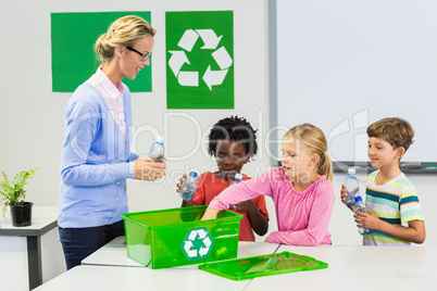 Teacher and kids discussing about recycle