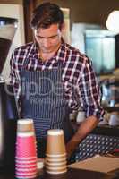 Waiter working at the till