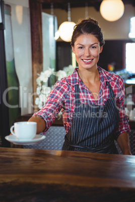 Waitress holding a cup of coffee