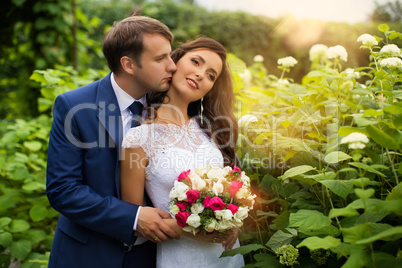 Newlyweds embracing in park