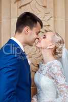 The groom kisses the bride tenderly