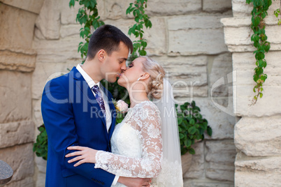 The groom kisses the bride tenderly