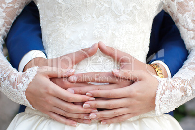 The groom gently hug the bride's hands