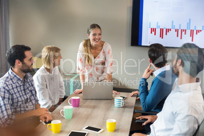 Business people discussing over graph during a meeting