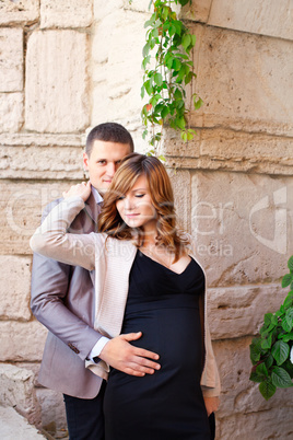 Man tenderly embraced Pregnant Woman