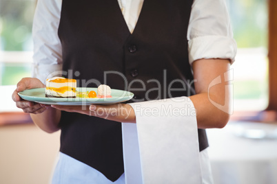 Waitress holding a plate with cakes