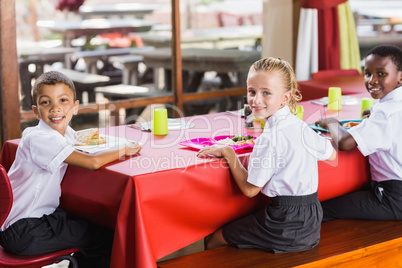 Children having lunch during break time in school cafeteria