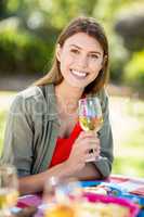 Portrait of woman holding wine glass and smiling