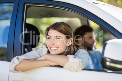 Thoughtful woman looking out from car window