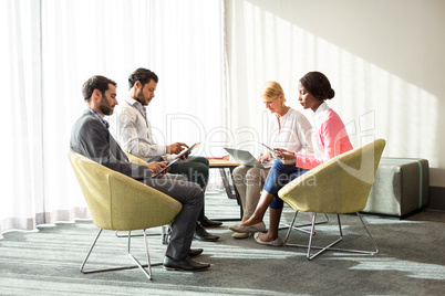 Business people using mobile phone, digital tablet and laptop