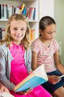 Schoolgirl reading a book in library