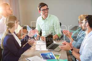 Coworkers applauding a colleague after presentation