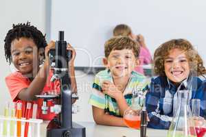 Portrait of kids doing experiment in laboratory