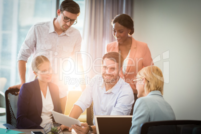 Group of business people interacting using digital tablet