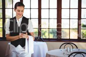 Waitress using mobile phone
