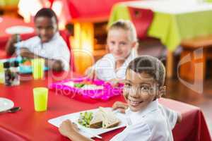 Children having lunch during break time in school cafeteria
