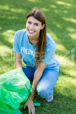 Portrait of volunteer woman collecting rubbish