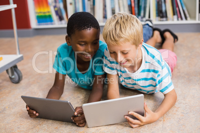 Kids using digital tablet in library