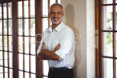 Smiling man with arms crossed