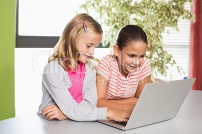 Kids using laptop in library