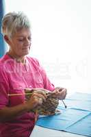Retired woman doing some knitting
