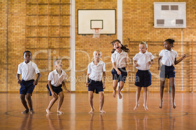 Group of students jumping in school gym