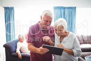 Senior people looking at a digital tablet