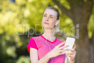 Beautiful woman listening music on mobile phone