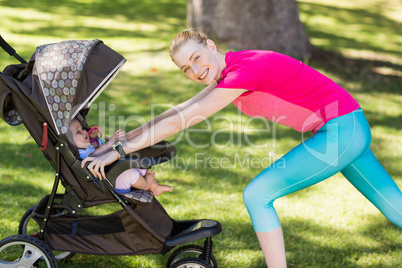 Woman exercising with baby stroller