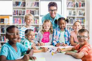 Portrait of teacher and kids in library