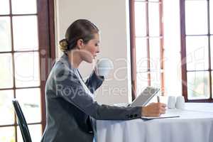 Woman working and drinking a coffee