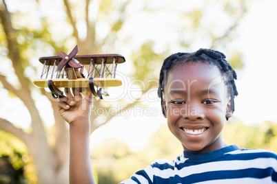 Happy boy smiling and holding a plane