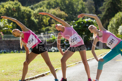 Female athletes warming up in park