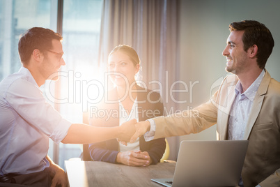 Businessman shaking hands with coworker