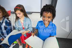 Kids reading book in classroom