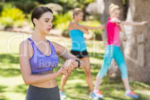 Woman checking time while exercising