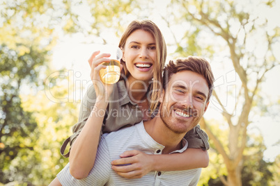 Man giving piggyback ride to women