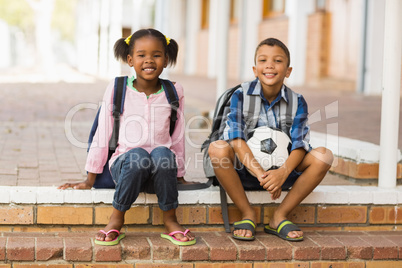 Portrait of kids sitting on stairs at school