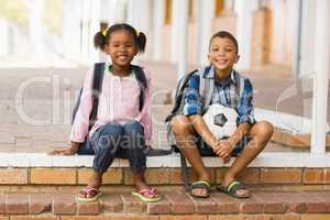 Portrait of kids sitting on stairs at school