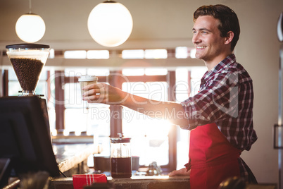 Waiter offering a cup of coffee
