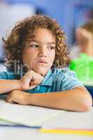 Close-up of thoughtful boy looking away while studying
