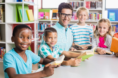 Portrait of teacher and kids in library