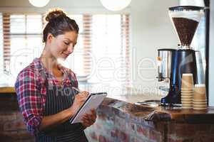 Waitress writing in a book