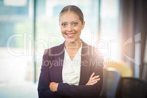 Businesswoman standing with arms crossed in the office